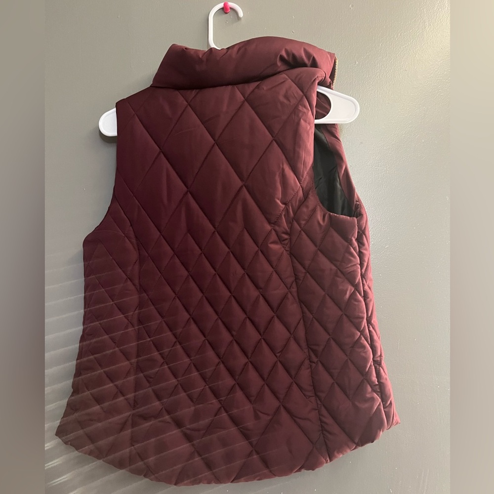 Burgundy vest with rose gold zipper and it’s black on the in side